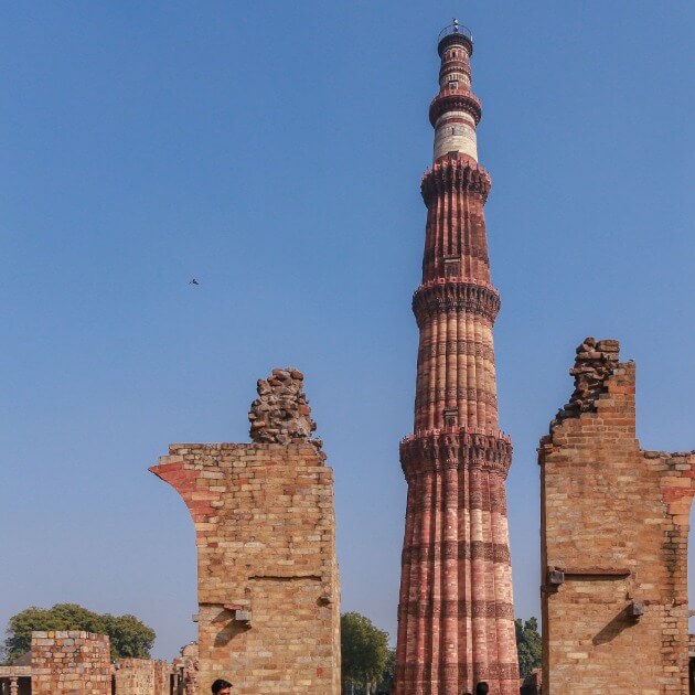 Load image into Gallery viewer, The stunning Qutub Minar, an ancient UNESCO World Heritage Site in Delhi, India, rising tall against the sky - Tailor-made India with Sandhya Balakrishnan - VendorYoga &amp; Nature - JOURNEY - Zhoola
