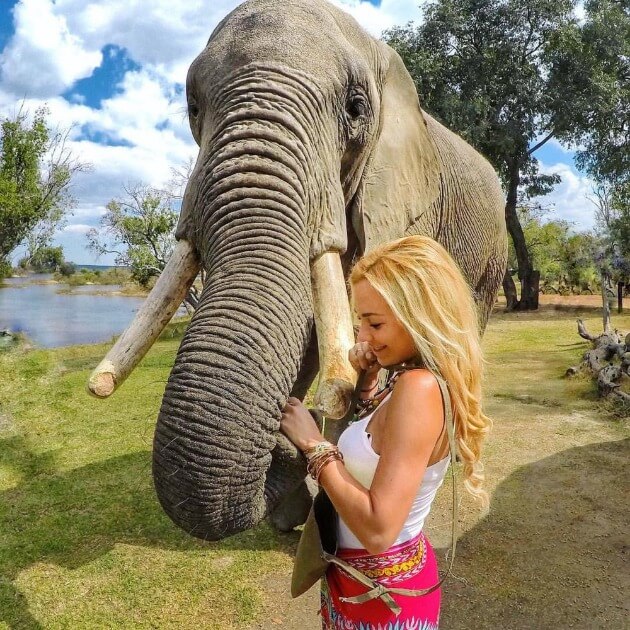 girl patting Elephant - Safari & Waterfalls in Africa with Alyssa Ramos - Safari & Culture (women only) - JOURNEY