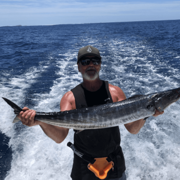 Load image into Gallery viewer, Freshly caught Wahoo fish, known for its delicious taste and a great catch for surfers to enjoy between surf sessions - Maldives SUP surf trip with Tiago Silva - Live Aboard Surfing - Zhoola

