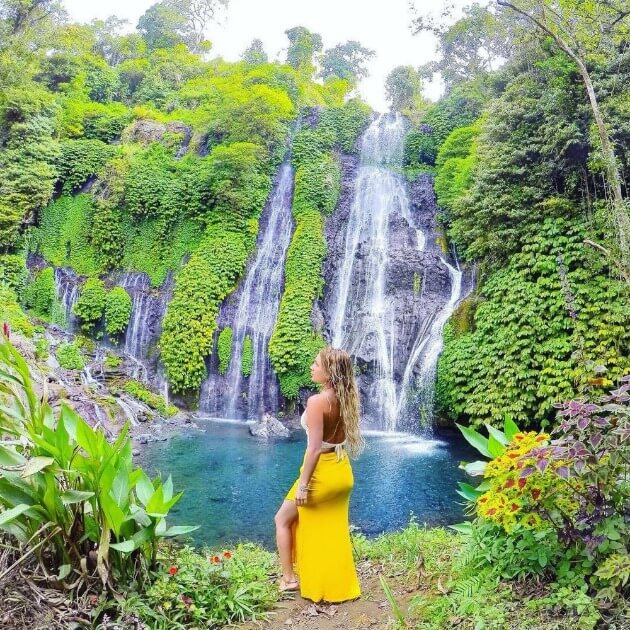 girl standing in front of  Waterfall - Safari & Waterfalls in Africa with Alyssa Ramos - Safari & Culture (women only) - JOURNEY