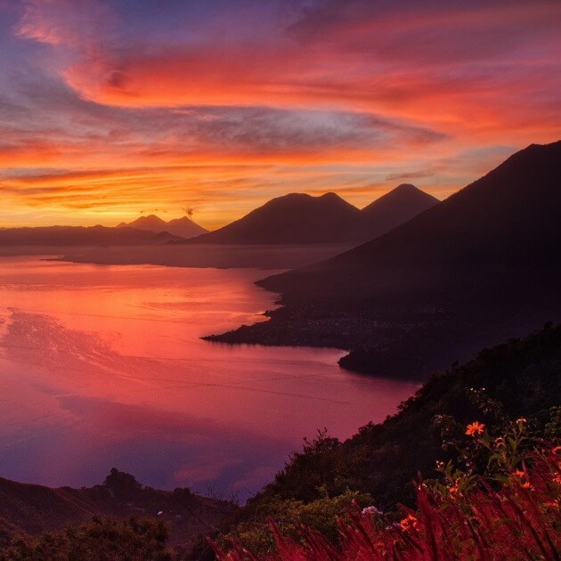 Load image into Gallery viewer, Breathtaking sunrise over Lake Atitlán with towering mountains in the background - Reset &amp; Reconnect with Thai James - Yoga &amp; Exploration - Retreat - Zhoola
