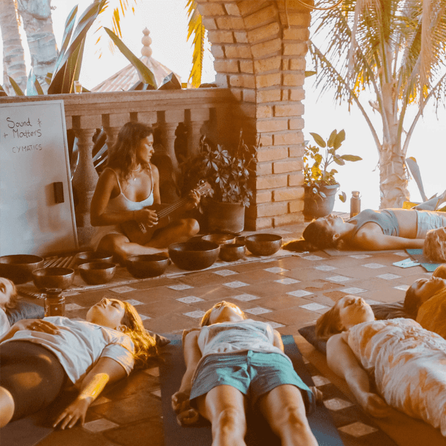 Load image into Gallery viewer, Yogis lying on the floor and forming a circle - Surf &amp; Underwater Training with Nette, Augusto &amp; Erika (Women Only) - Surfing &amp; Yoga - Retreat - Zhoola
