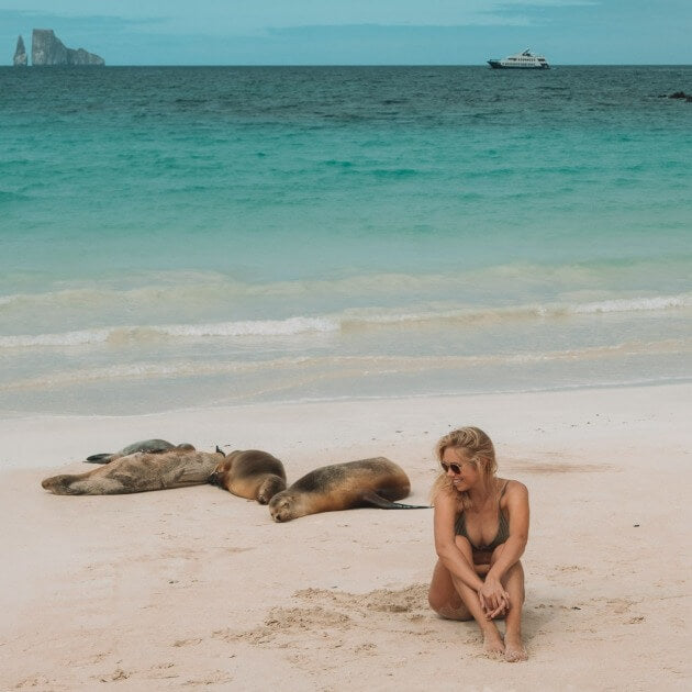 Load image into Gallery viewer, Girl enjoying the company of a sea lion on a beautiful Galapagos beach - Luxury Galapagos with Kiersten, Caity &amp; Cecibel - Cruise &amp; Eco (Women only) - Expedition - Zhoola
