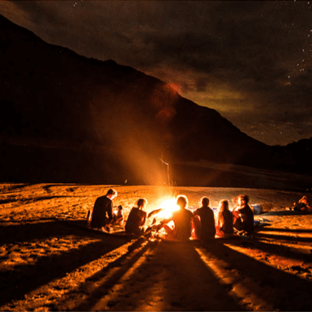 Bonfire night with people gathered around the fire - Kingdom of clouds with Luigi Marmanillo - Rafting & camping - EXPEDITION