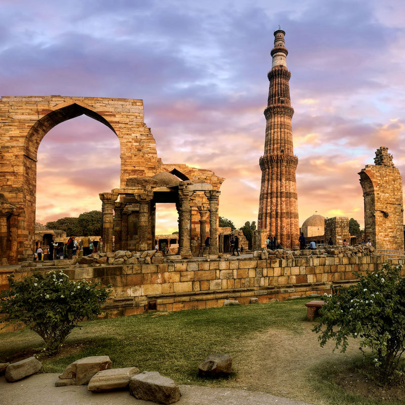 Load image into Gallery viewer, The stunning Qutub Minar, an ancient UNESCO World Heritage Site in Delhi, India, rising tall against the sky.Signature India with Sandhya Balakrishnan - Yoga &amp; Exploration - Journey - Zhoola
